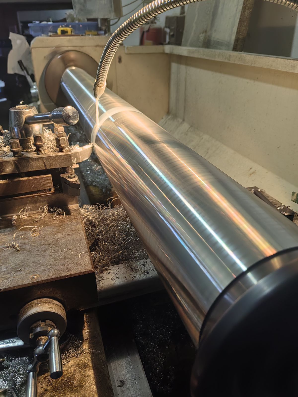Mirror-finish steel shaft being turned